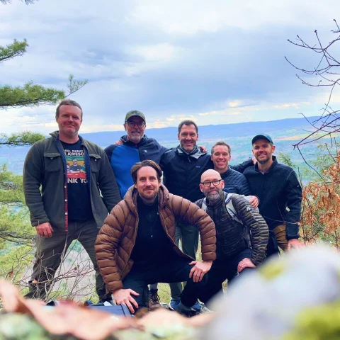 Andrew Schultz with a group of men on a mountain retreat.