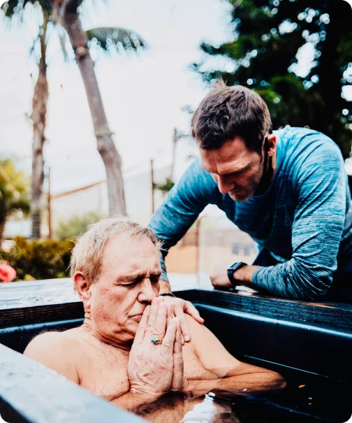 Andrew Schultz guiding a client through a cold water therapy session.