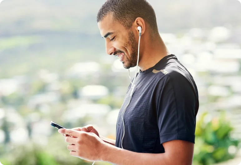 Man listening to a podcast on his phone with earphones.